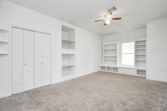 unfurnished living room featuring ceiling fan and carpet floors