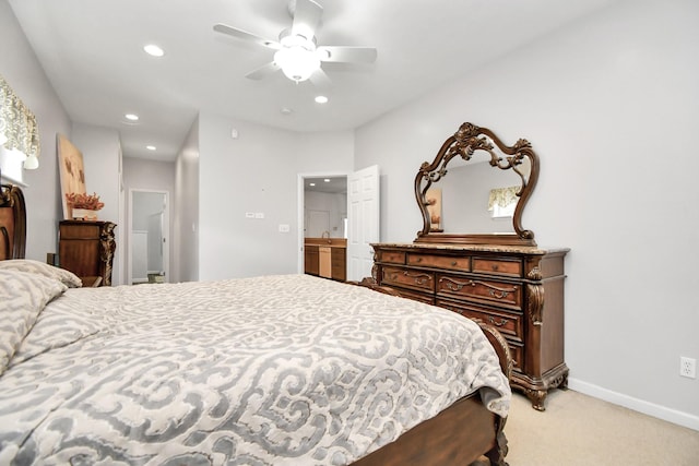 carpeted bedroom with ceiling fan and ensuite bathroom