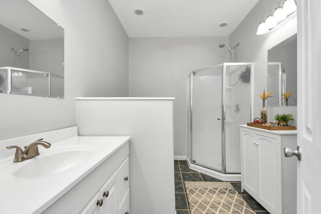 bathroom with tile patterned floors, vanity, and a shower with door