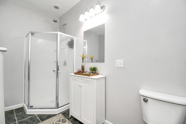 bathroom featuring toilet, a shower with door, and tile patterned flooring