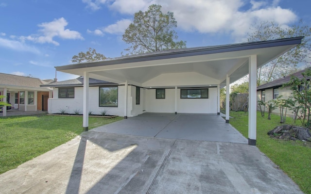 view of front facade with a carport and a front yard