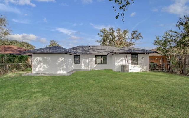 rear view of property with a lawn