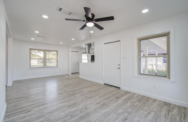 unfurnished living room with light hardwood / wood-style flooring and ceiling fan