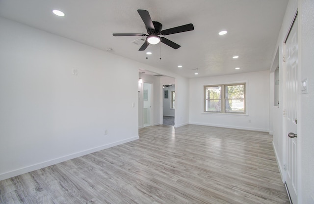 empty room featuring ceiling fan and light hardwood / wood-style floors