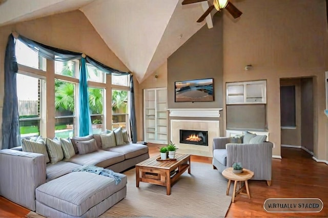 living room featuring hardwood / wood-style flooring, high vaulted ceiling, and ceiling fan