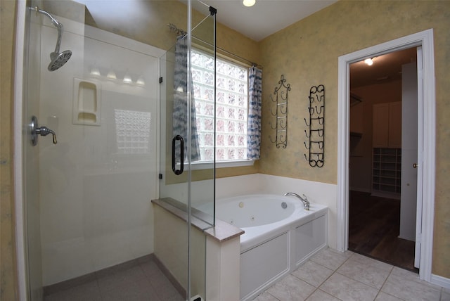 bathroom featuring tile patterned flooring and plus walk in shower