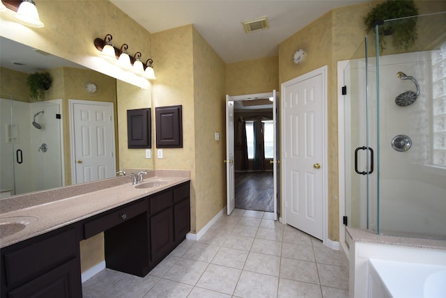 bathroom featuring tile patterned flooring, vanity, and separate shower and tub