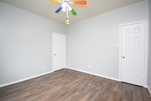 unfurnished room with dark hardwood / wood-style flooring and ceiling fan