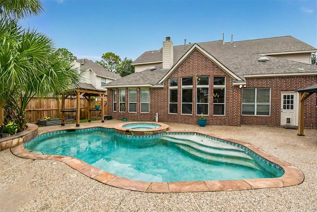 view of pool featuring a gazebo, a patio area, and an in ground hot tub