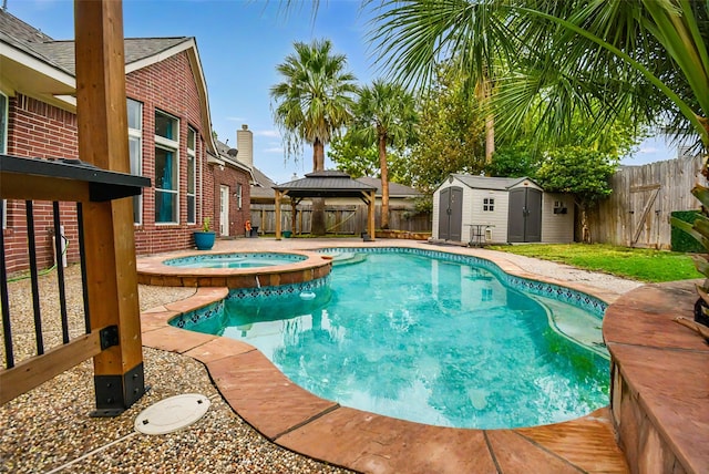 view of pool with a gazebo, an in ground hot tub, and a shed