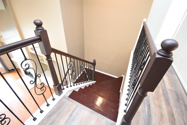 stairs featuring hardwood / wood-style floors