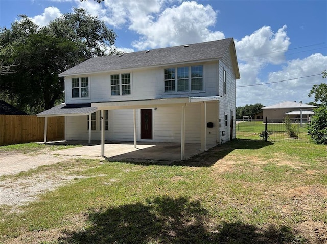 rear view of property with a lawn and a patio area