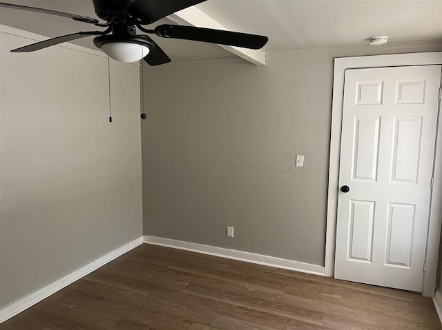 empty room with dark hardwood / wood-style floors, ceiling fan, and ornamental molding