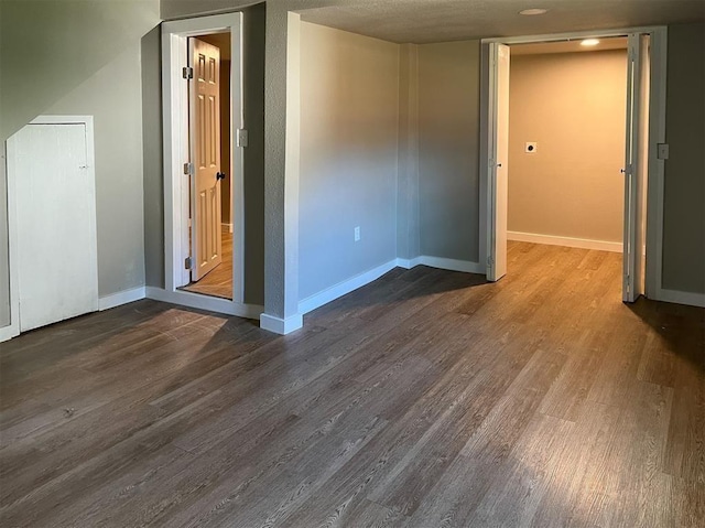 unfurnished room with dark wood-type flooring