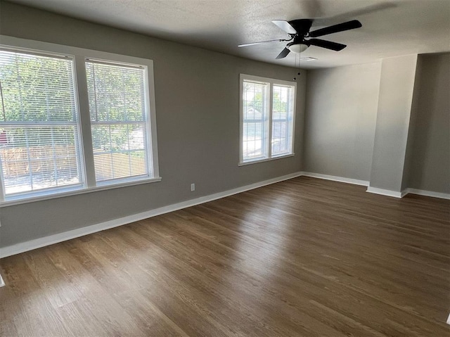 empty room featuring ceiling fan, dark hardwood / wood-style flooring, and a textured ceiling