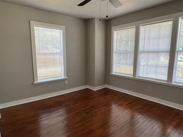 empty room featuring dark hardwood / wood-style floors and ceiling fan