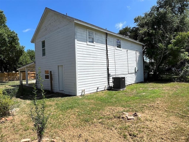 view of property exterior featuring a yard and central AC unit