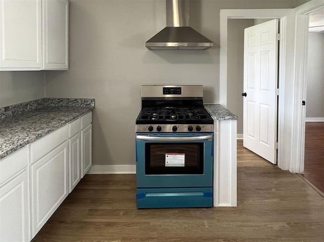 kitchen with gas stove, white cabinetry, dark hardwood / wood-style flooring, and wall chimney exhaust hood