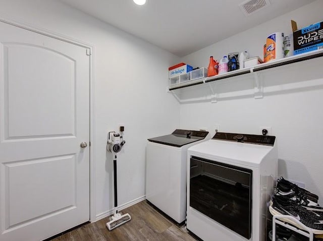 washroom with washer and clothes dryer and dark hardwood / wood-style floors