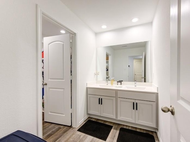 bathroom featuring hardwood / wood-style flooring and vanity