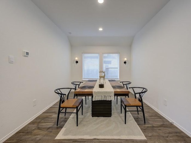 dining room with lofted ceiling and dark hardwood / wood-style floors