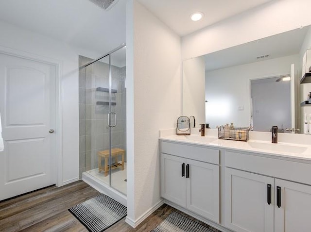 bathroom featuring vanity, hardwood / wood-style floors, and a shower with shower door