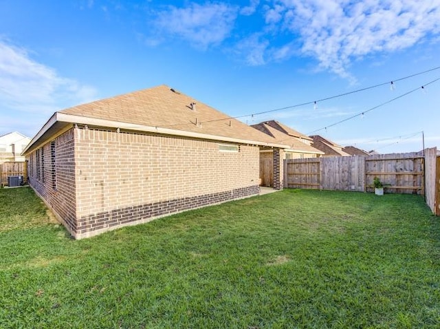 exterior space featuring cooling unit and a yard