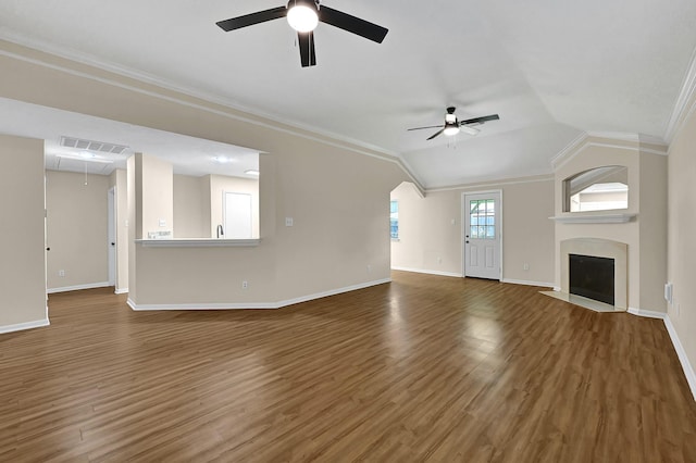 unfurnished living room featuring crown molding, ceiling fan, dark wood-type flooring, and lofted ceiling