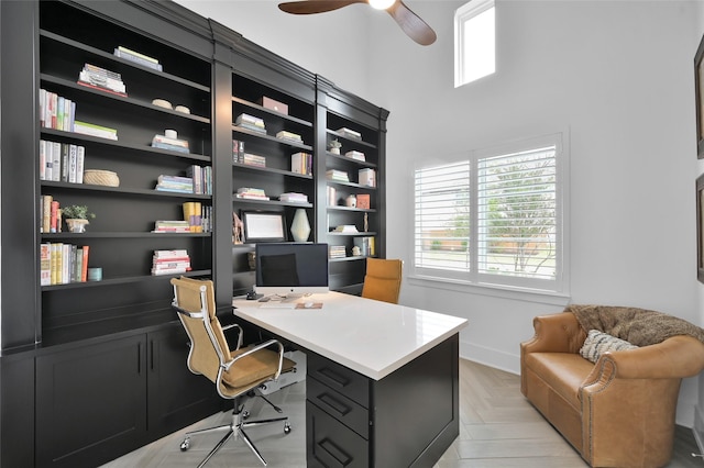 office space featuring ceiling fan and light parquet flooring