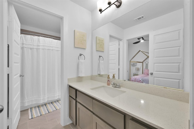 bathroom featuring tile patterned floors, vanity, and ceiling fan