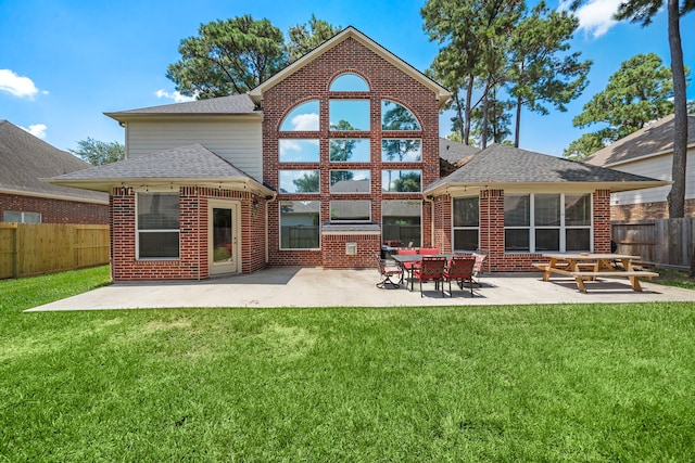 rear view of house with a lawn and a patio area