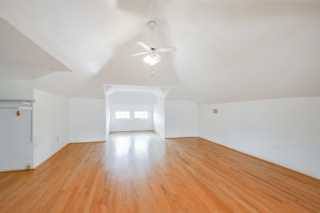 additional living space with ceiling fan, light hardwood / wood-style floors, and lofted ceiling