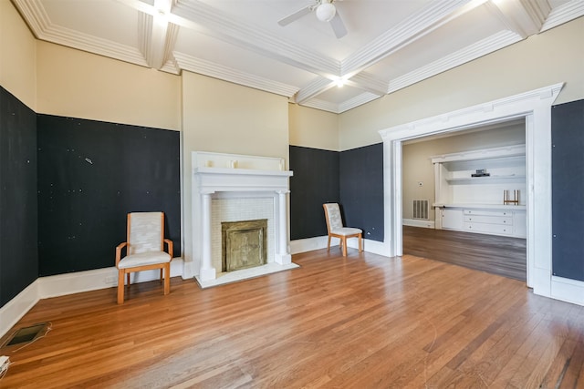 unfurnished living room with coffered ceiling, ceiling fan, ornamental molding, beamed ceiling, and light hardwood / wood-style floors