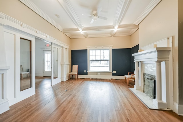 unfurnished living room featuring coffered ceiling, crown molding, ceiling fan, light wood-type flooring, and beam ceiling