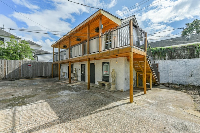 rear view of house featuring a wooden deck