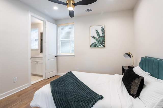 bedroom with light wood-type flooring, connected bathroom, and ceiling fan