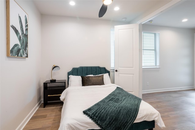 bedroom with ceiling fan and hardwood / wood-style flooring