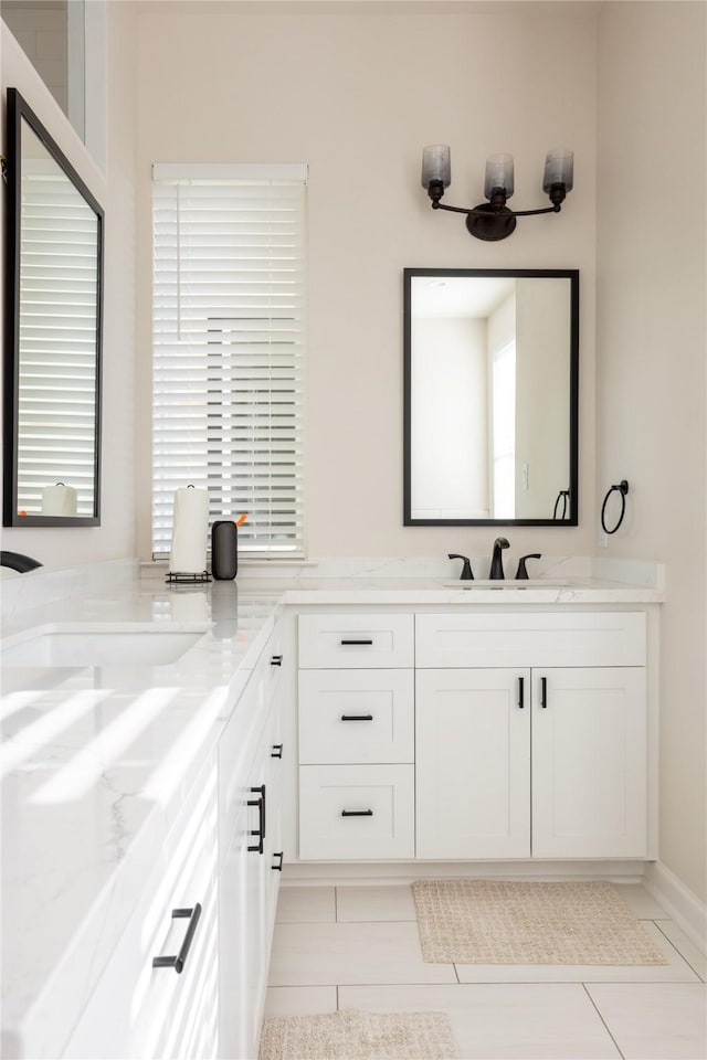 bathroom with vanity, tile patterned floors, and a healthy amount of sunlight