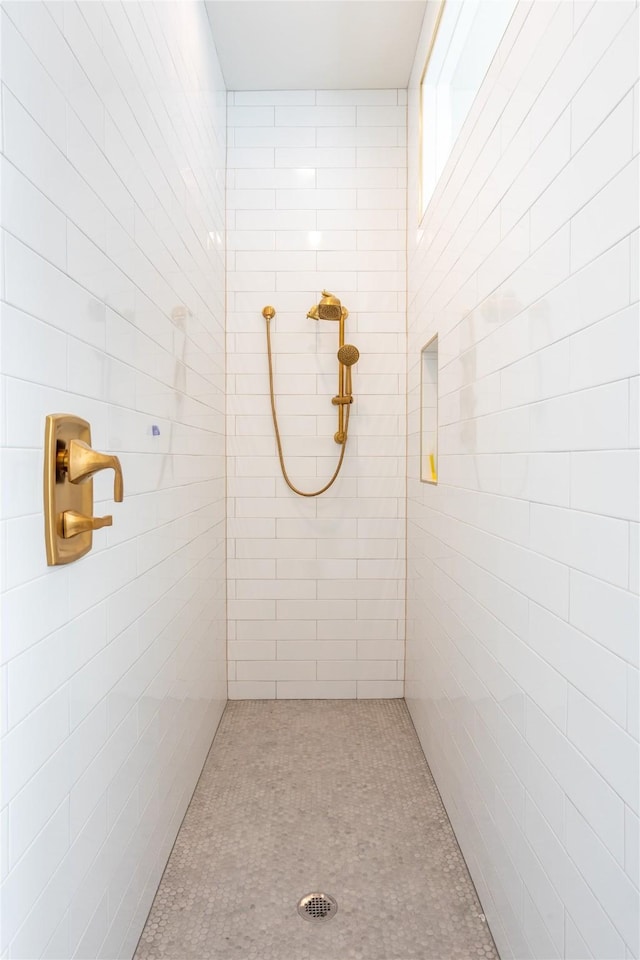 bathroom with a tile shower