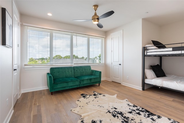 sitting room with hardwood / wood-style floors, plenty of natural light, and ceiling fan