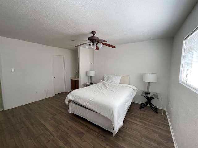 bedroom featuring ceiling fan, dark hardwood / wood-style flooring, and a textured ceiling