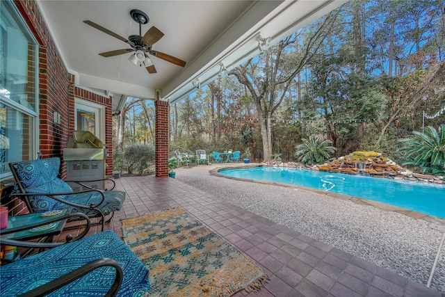 view of pool with a patio area and ceiling fan