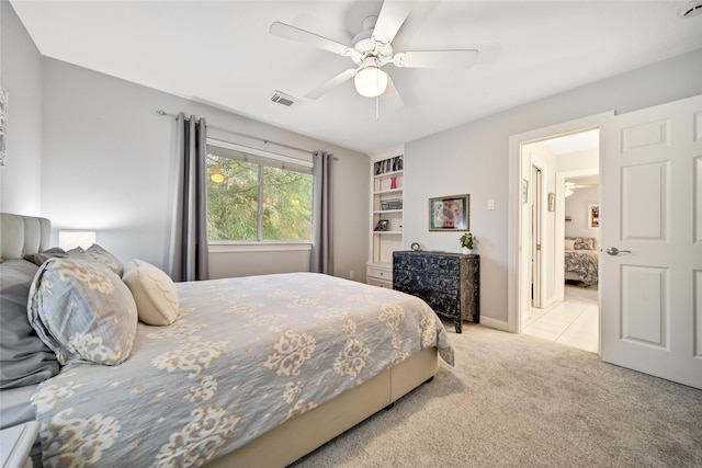 bedroom with ceiling fan and light colored carpet