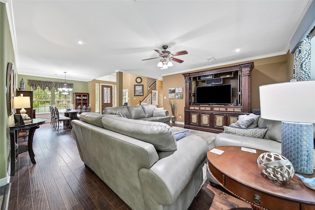 living room with ceiling fan with notable chandelier, dark hardwood / wood-style flooring, and crown molding