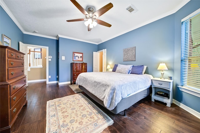 bedroom with dark hardwood / wood-style flooring, ceiling fan, and crown molding