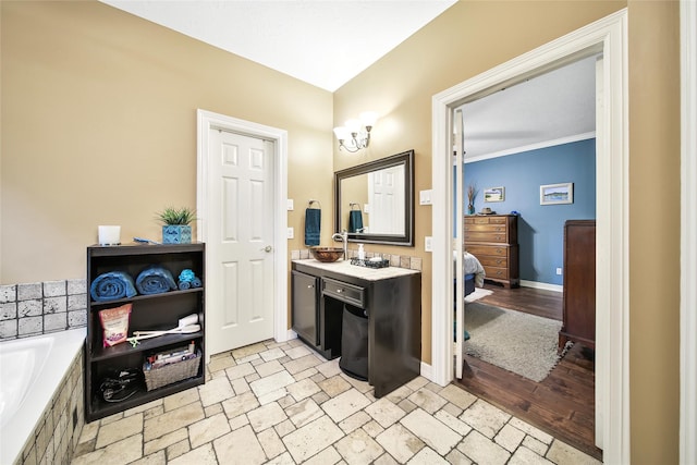 bathroom featuring vanity, a relaxing tiled tub, wood-type flooring, and ornamental molding