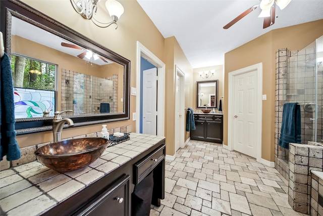 bathroom with vanity and a tile shower