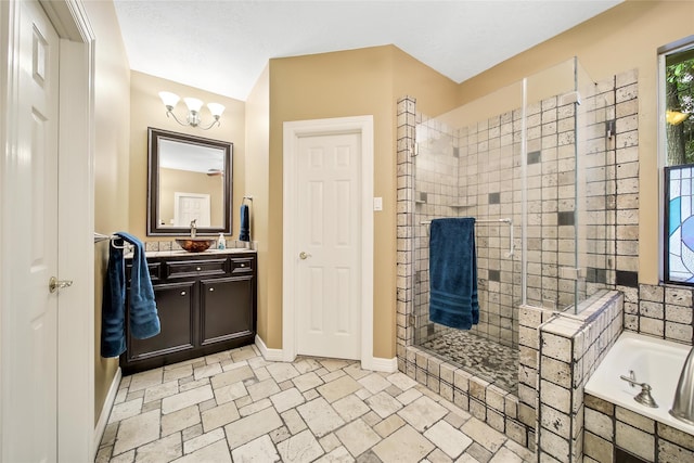 bathroom featuring vanity, a textured ceiling, plus walk in shower, and an inviting chandelier