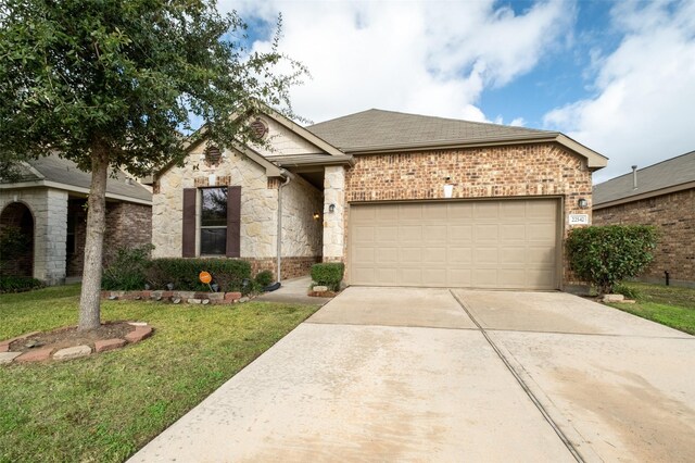 view of front of home with a front lawn and a garage