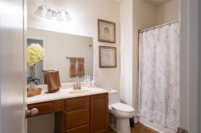 bathroom featuring vanity, toilet, and curtained shower